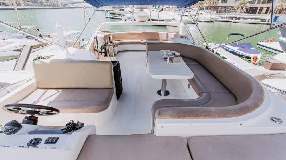 top deck of yacht with ample leather seating space, table,